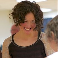 Rozi smiling at a participant in a workshop